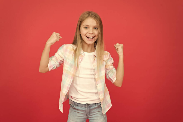 Feeling awesome. Happy childhood. Girl child smiling face expression on red background. Positive emotions concept. Happy childrens day. Being happy every day. Schoolgirl casual style emotional kid - Foto, afbeelding