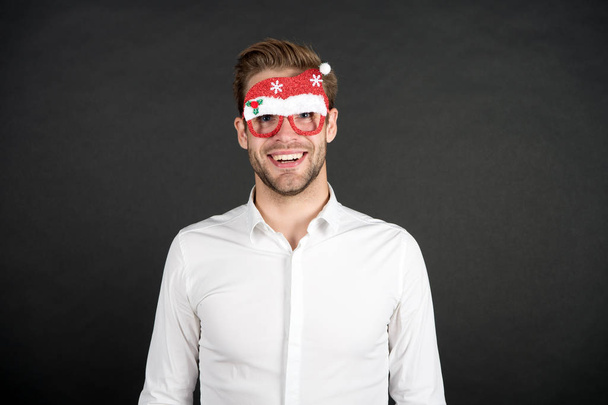 Happy holidays. Merry christmas. Man white shirt posing with photo booth props. Winter holidays. Corporate party. Santa claus coming. Guy celebrate new year. Cheerful ideas for holidays celebration - Photo, Image