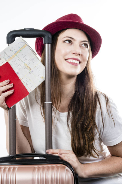 Beautiful happy woman with suitcase and passport on white background. Air flight concept. - Фото, изображение