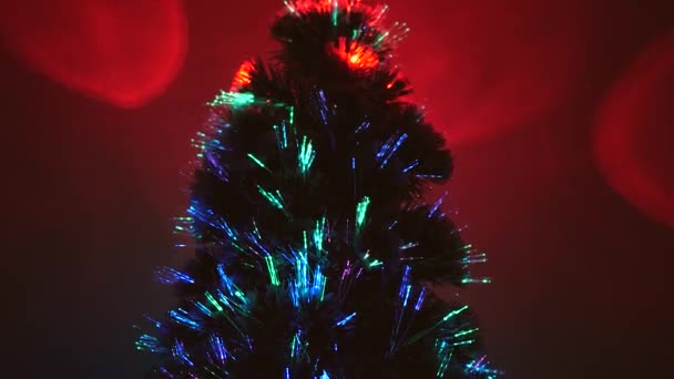 magical Christmas artificial tree with a star in room, decorated with a luminous multi-colored garland. New Year .Christmas tree, happy holidays. Christmas interior. holiday for children and adults. - Footage, Video