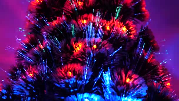 multi-colored Christmas tree, happy holidays. New Year 2020 mood. Christmas interior. beautiful Christmas tree in room, decorated with a luminous garland and star. holiday for children and adults. - Footage, Video