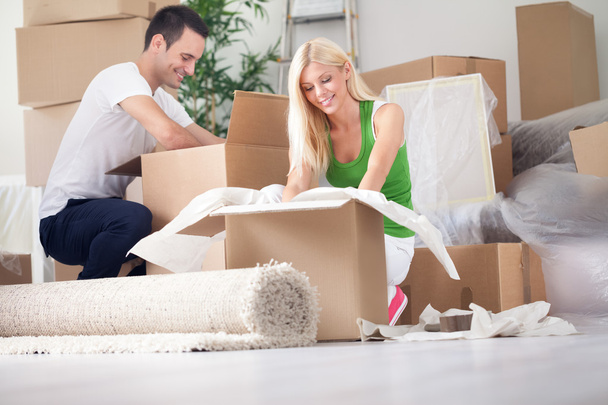 young couple unpacking or packing boxes - Фото, изображение