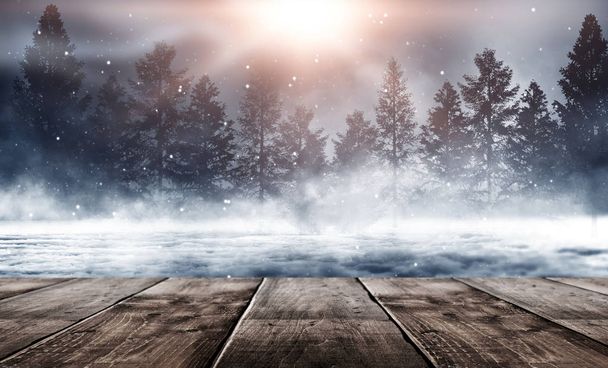Dark winter forest background at night. Winter snow landscape with wooden table in front. Snow, fog, moonlight. Dark neon night background in the forest with moonlight. Neon figure in the center. Night view, magic. - Фото, зображення