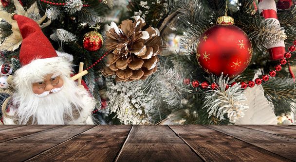 Christmas holiday table. Empty festive scene, wooden table. Lanterns and balls, beads on the branches of a Christmas tree. Christmas toys and decorations. Christmas and New Year background. - Photo, Image