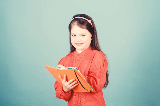 Lets look in the book of scientific knowledge. Cute little child writing knowledge test report. Adorable small girl holding book knowledge in hands. Knowledge day or September 1 - Foto, Bild