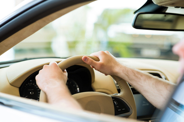 male hand holding a car wheel - Fotó, kép
