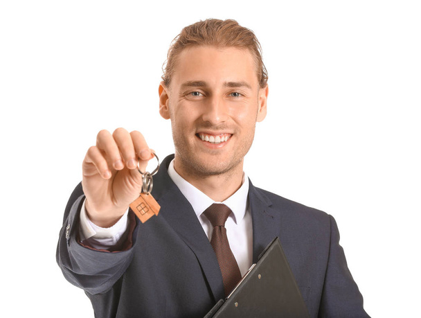 Male real estate agent with key on white background - Photo, Image