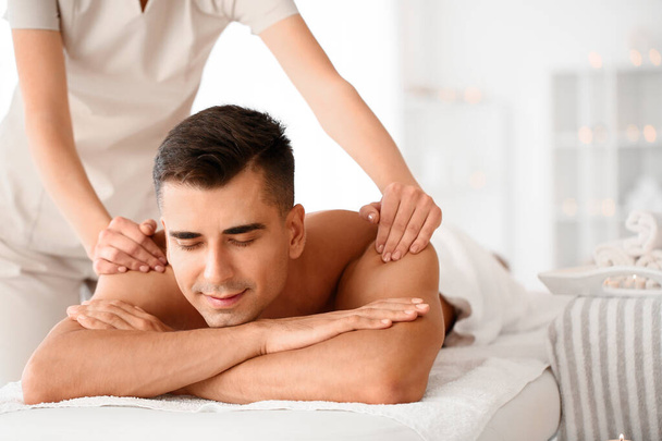 Handsome man having massage in spa salon - Photo, Image