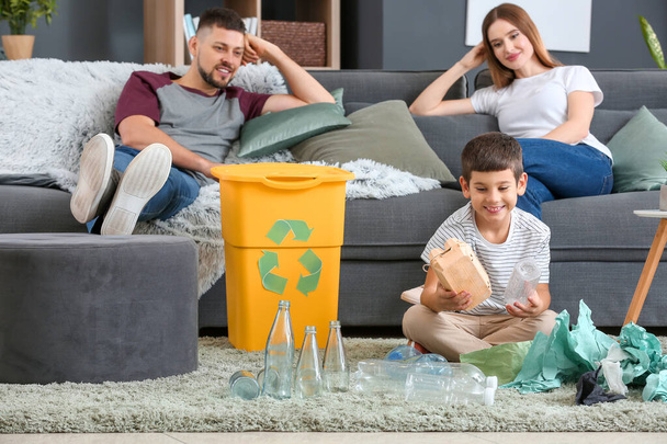 Family with garbage and container at home. Concept of recycling - Fotografie, Obrázek