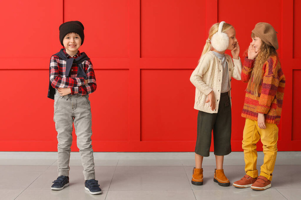 Bambini piccoli e carini in abiti autunnali vicino alla parete di colore
 - Foto, immagini