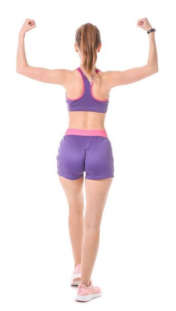 Sporty young woman on white background, back view - Photo, Image