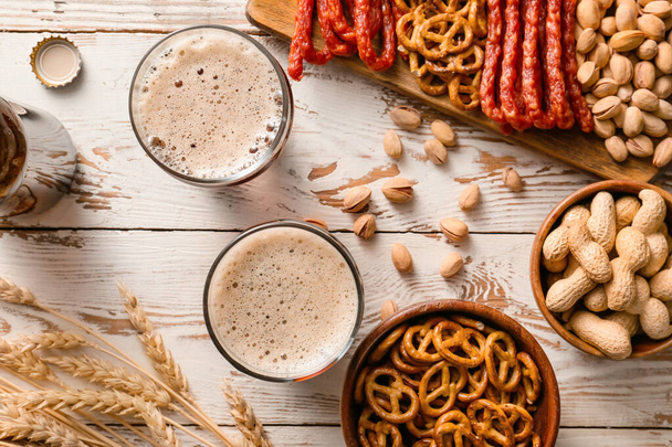 Composition with fresh beer and snacks on wooden background - Foto, Imagem