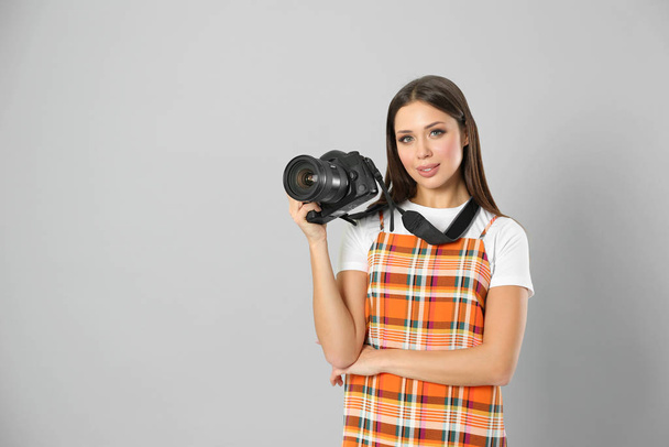 Professional photographer working on light grey background in st - 写真・画像