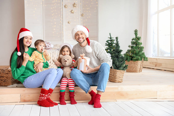 Happy family with Christmas gift at home - Foto, imagen