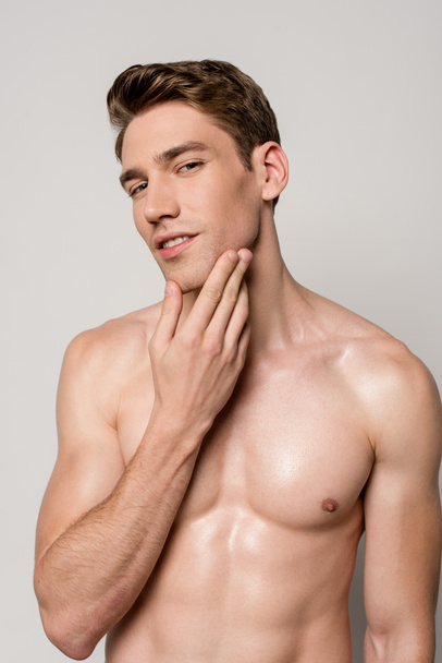 sexy man with muscular torso touching skin isolated on grey - Φωτογραφία, εικόνα