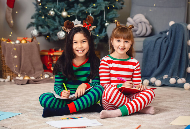 Cute little girls writing letter to Santa Claus on Christmas eve at home - Photo, Image