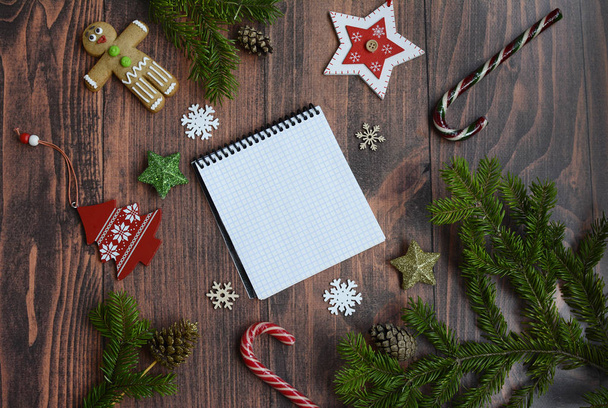 Christmas background with snowflakes, Christmas toys, stars, spruce branches and a notebook for writing, top view - Photo, image