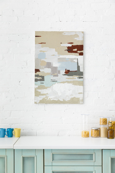 white and turquoise kitchen interior with abstract painting on brick wall - Photo, Image