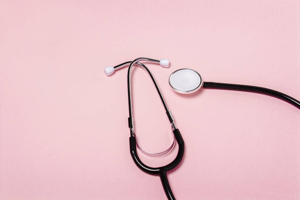Medical stethoscope on a pink background. Concept of health care, medicine, virus, epidemic, high quality, the best in the world. Banner. Flat lay, top view - 写真・画像