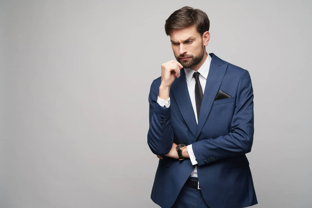 Studuo shot of thinking businessman wearing suit - Fotografie, Obrázek