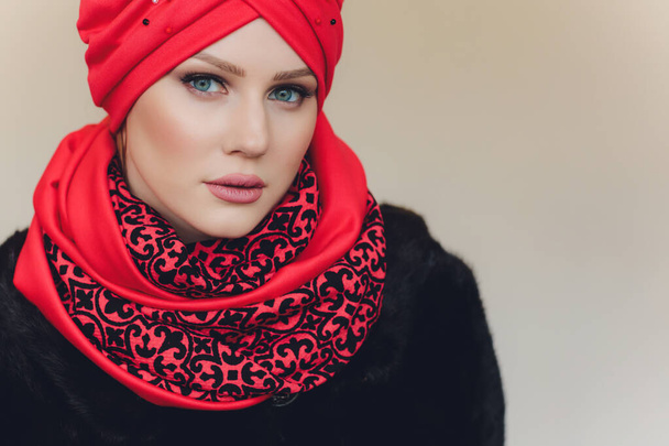 Photo of self assured Arabian lady in hijab, shows you right way, points at blank space with both fore fingers, invites going there, promots copy space. Check it out with me. - Valokuva, kuva