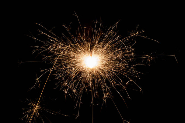 Burning sparkler, fireworks for holidays includes christmas, happy new year - Foto, afbeelding