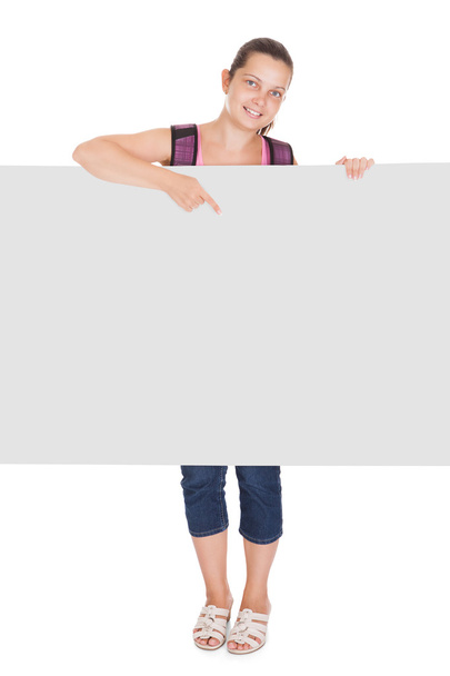Female student pointing on placard - Foto, imagen