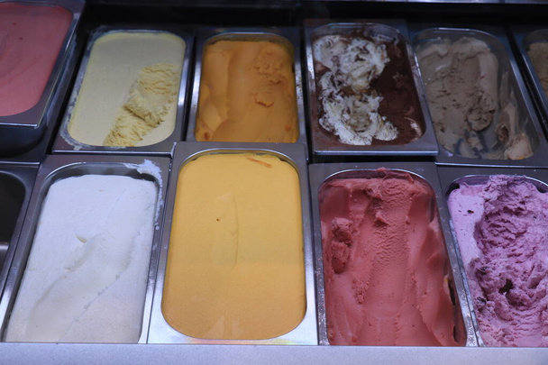 Assorted ice cream flavors in metal tubs - Photo, Image