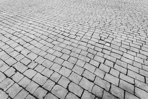 Вид зверху на тротуарну кам'яну дорогу. Старий тротуар з гранітної текстури
.  - Фото, зображення