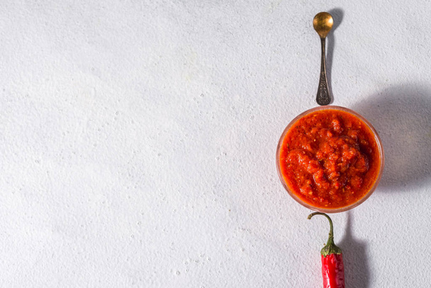 Traditional mexican, georgian and arabic harissa pepper paste on a white concrete background. Useful spicy food - Foto, imagen