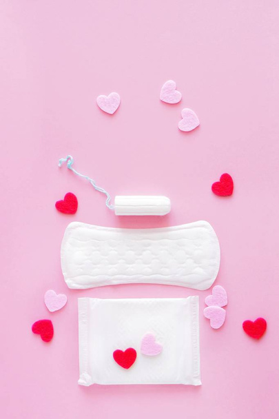 Sanitary tampon  and pads on a pink background. An alternative choice of feminine hygiene products. Menstrual mothly cycle, means of protection. Top view, flat lay, copy space for text. - Photo, Image
