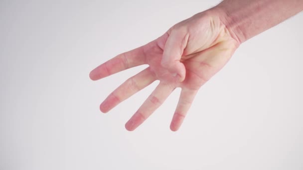Un jeune homme montre un compte à rebours de 5 à 0 en utilisant ses doigts sur un fond blanc. Langue des signes internationale. Heure approximative de début
 - Séquence, vidéo