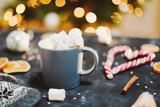 Cup with marshmallows, candy cane, tangerines.  New Year still life. Christmas tree. Christmas, winter, New year concept. Flat lay - Foto, Imagem