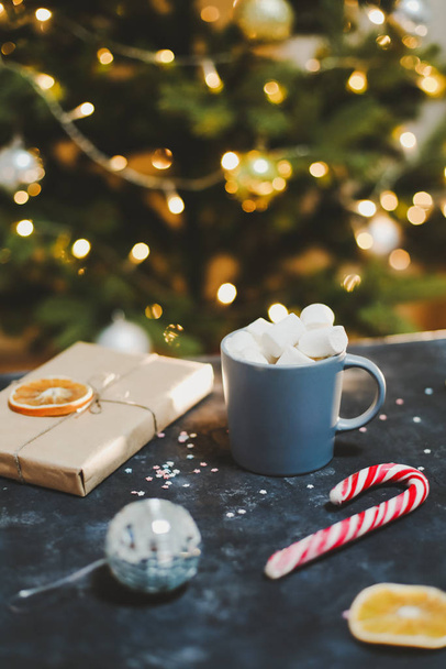 Cup with marshmallows, candy cane, tangerines.  New Year still life. Christmas tree. Christmas, winter, New year concept. Flat lay - Fotoğraf, Görsel