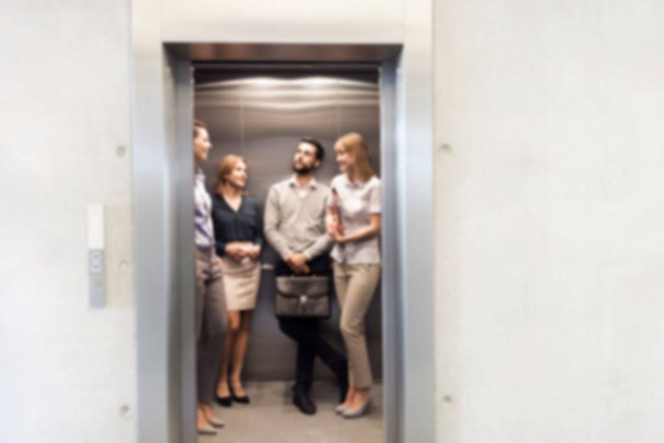 Business people waiting for elevator in office building - Zdjęcie, obraz