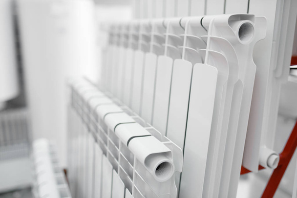Water heating radiators choice on showcase in plumbering store. Sanitary engineering shop, nobody - Фото, зображення