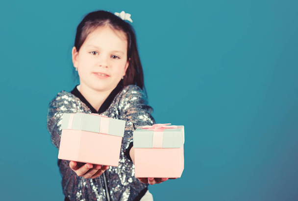 Shopping day. Cute child carry gift boxes. Surprise gift box. Birthday wish list. World of happiness. Special happens every day. Choose one. Girl with gift boxes blue background. Black friday - Foto, Bild