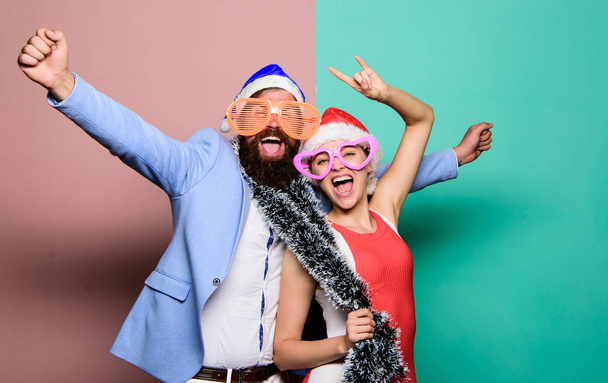 Christmas fun. happy family couple celebrate xmas. santa man and woman with tinsel. merry christmas. preparation to winter holidays. celebrate together. people in party glasses. happy new year party - 写真・画像