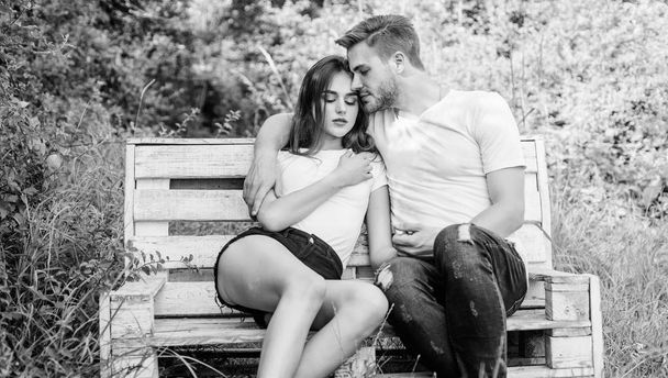 Boyfriend girlfriend in love. Lovers cuddling. Couple in love sit on bench. Summer vacation. Family weekend. Romantic date in park. Trust and intimacy. Youth hang out. Love and romance concept - Foto, afbeelding