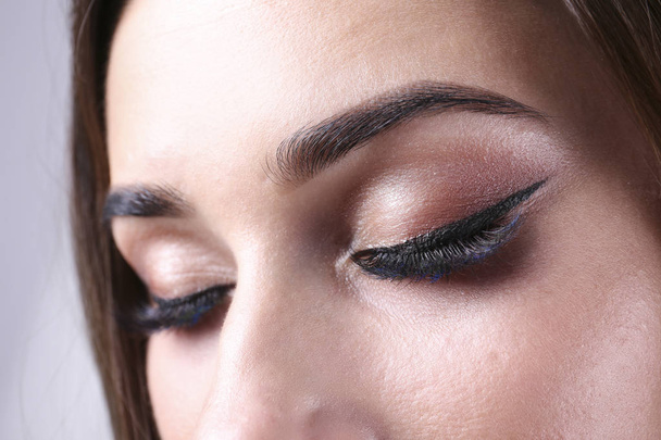 Close up portrait of female with brunette hair showing her makeup. - Foto, Imagem