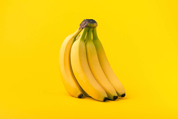 Bunch of bananas on yellow  - Фото, зображення