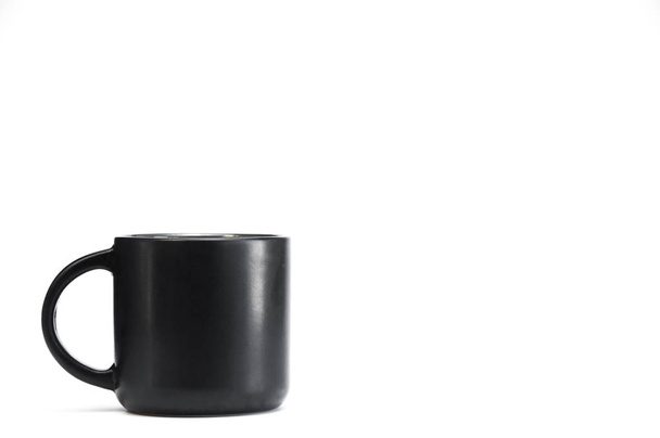 Black cup with tea or coffee on a white background. - Fotografie, Obrázek