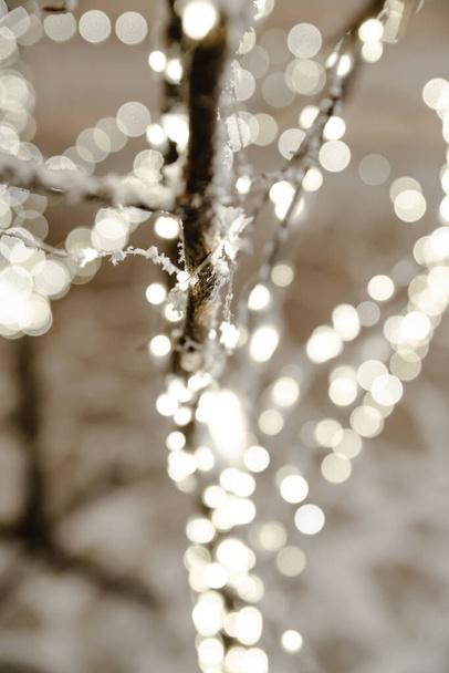 Christmas decor. Bright christmas decorations and garlands on snow Christmas tree - Photo, Image