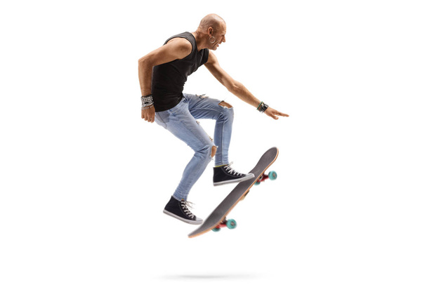 Male skateboarder jumping with a skateboard - Foto, Imagen