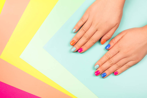 Neon manicure on multicolored bright background in trendy colors. - Foto, Imagem