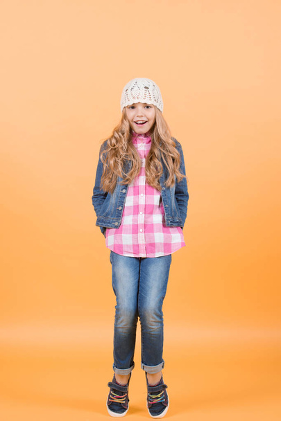 Child model with long blond hair smile and stand tiptoe - Foto, afbeelding