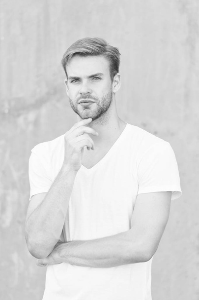 Male beauty standards. Handsome man unshaven face stylish hairstyle. Handsome caucasian man gray background. Ideal traits that make man physically attractive. Bearded guy casual style close up - Foto, imagen