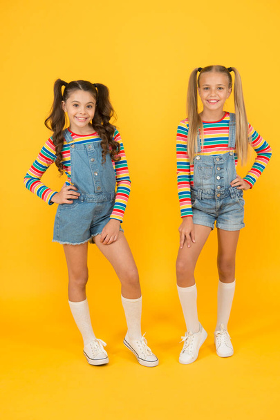 Hip and stylish. best friends forever. small sisters have fun. little girls yellow background. hairdresser salon. kid summer fashion. beauty and style. childhood happiness. happy school friendship - Photo, image