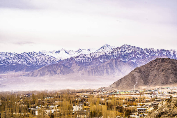 View landscape and cityscape of Leh Ladakh Village with Himalaya mountain range from viewpoint of Leh Stok Palace while winter season in Jammu and Kashmir, India - Fotó, kép