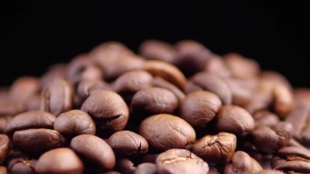 Dark Coffee Grains. Rotating and falling. Coffee beans. - Video